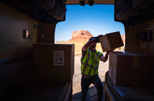 istock Delivery man checking packages on his van 1398043844
