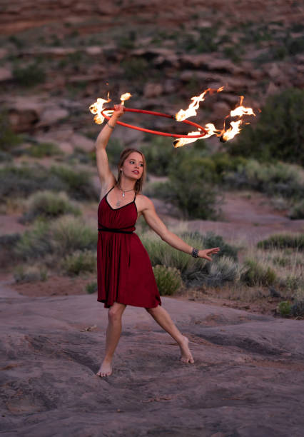 istock Young woman dancing with fire 1398043895