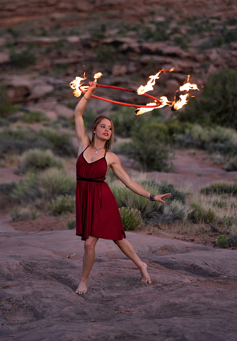 Young woman dancing with fire