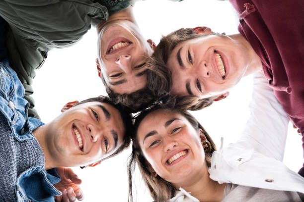 istock Low angle view of teenager group looking down 1398045017