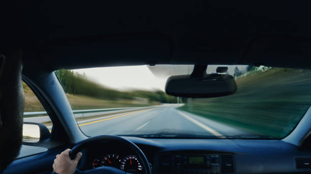 istock Hands on the wheel when driving at high speed from inside the car. Abstract motion blur. 1398045925