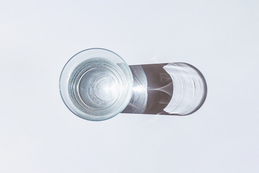 View of one single glass with fresh water at normal temperature on white background.