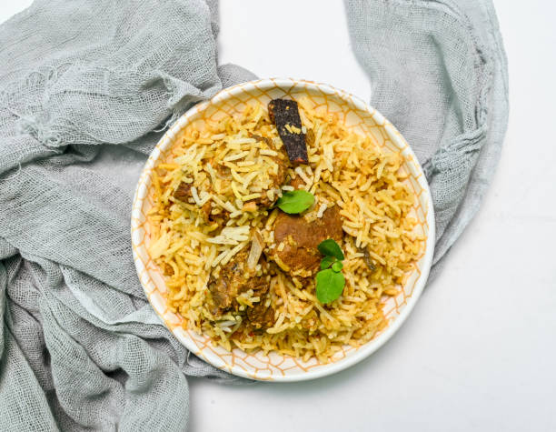 istock Delicious mutton biryani top view.Biryani rice dish Beautiful Indian rice dish.Delicious spicy chicken biryani in bowl over moody background, it’s a popular Indian and Pakistani food. 1398046210