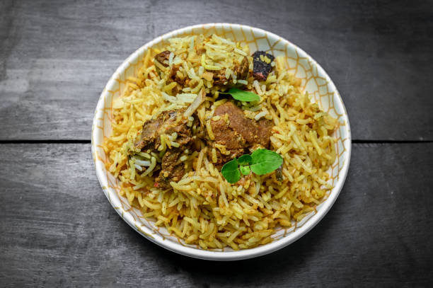 istock Delicious mutton biryani top view.Biryani rice dish Beautiful Indian rice dish.Delicious spicy chicken biryani in bowl over moody background, it’s a popular Indian and Pakistani food. 1398046245
