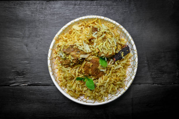 istock Delicious mutton biryani top view.Biryani rice dish Beautiful Indian rice dish.Delicious spicy chicken biryani in bowl over moody background, it’s a popular Indian and Pakistani food. 1398046254