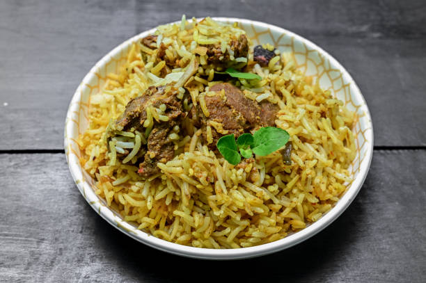 istock Delicious mutton biryani top view.Biryani rice dish Beautiful Indian rice dish.Delicious spicy chicken biryani in bowl over moody background, it’s a popular Indian and Pakistani food. 1398046259