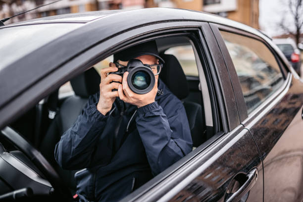 istock Private Detective Taking Photos At Stake-out 1398047202