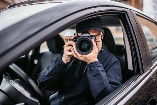 istock Private Detective Taking Photos At Stake-out 1398047217
