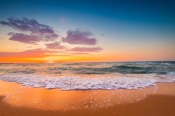 istock Beautiful sunrise over the sea sand and beach 1398048113