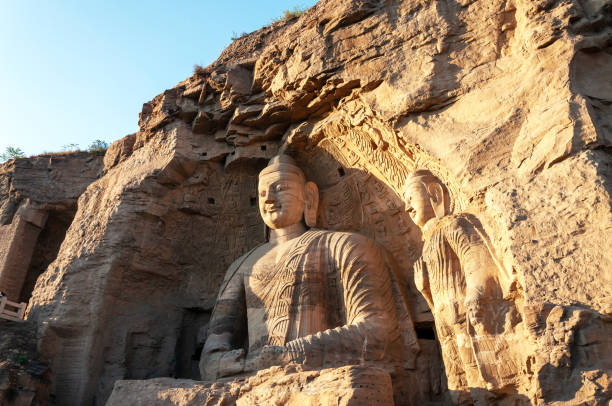 the buddha statue at yungang grottoes, its an ancient buddhist temple grottoes near the city of datong in the chinese province of shanxi. - carved rock imagens e fotografias de stock
