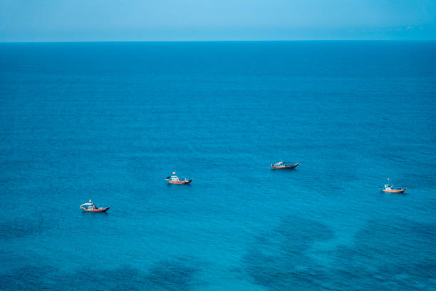 istock Beautiful blue sea with small ship from away 1398049253