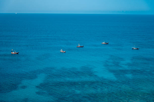 istock Beautiful blue sea with small ship from away 1398049257