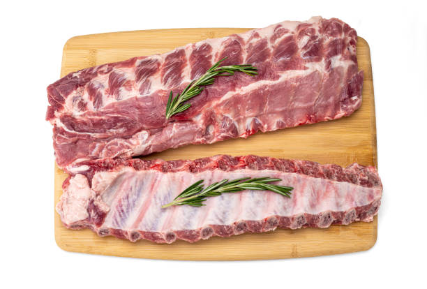 raw pork ribs with spices on cutting board. fresh pork ribs with rosemary on a wooden board, top view. Fresh meat and ingredients. Butchery, market raw pork ribs with spices on cutting board, isolated on white, top view. Fresh meat and ingredients. Butchery, market animal back stock pictures, royalty-free photos & images