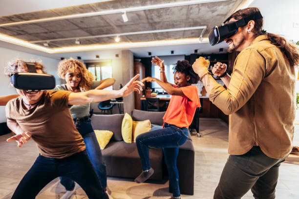 istock Cheerful friends having fun with VR in home interior 1398051724
