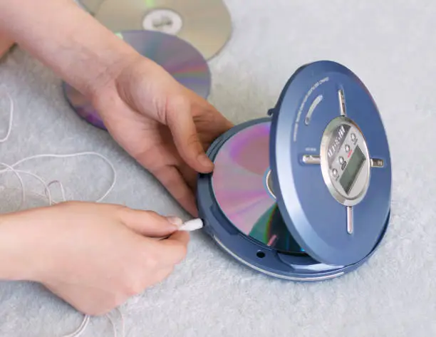 Photo of The girl connects headphones to the CD player to listen to new popular music. Recreation entertainment leisure teenager