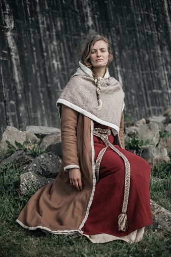 A Beautiful blonde Viking Woman outdoors on a settlement