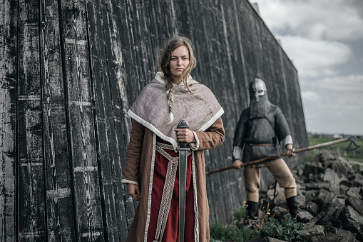 A Beautiful blonde Viking Woman at the village gate