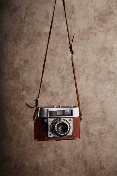 istock Analog vintage 35mm  film camera hanging on its strap 1398054530