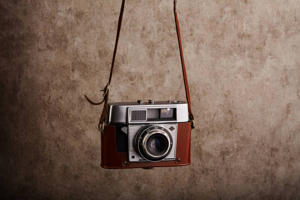 istock Analog vintage 35mm  film camera hanging on its strap 1398055258
