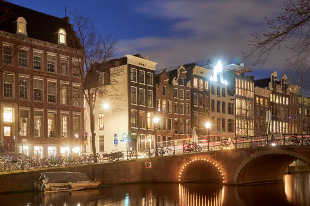 istock Amsterdam canal cityscape at night 1398055273