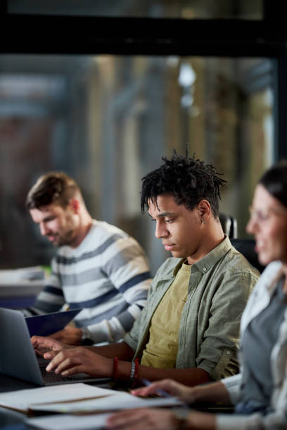 istock Black male programmer working on laptop in the office. 1398055719