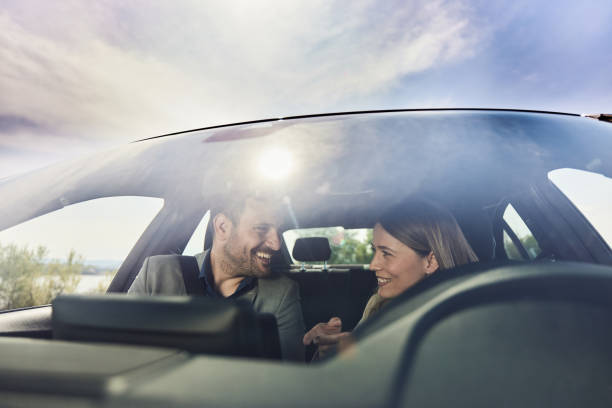 istock Happy business colleagues talking while going on a trip by car. 1398056829