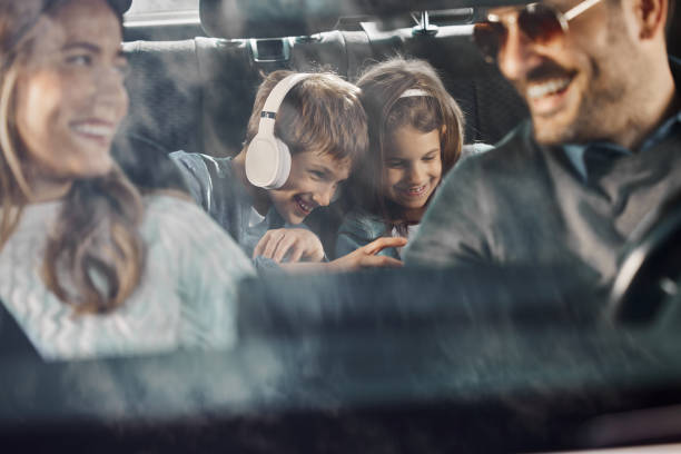 istock Happy kids enjoying while going on family vacation by car. 1398056908