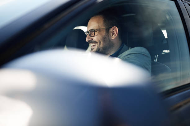 istock Happy businessman going on a trip by car. 1398057672