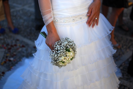 Woman dressed as a bride holding the bouquet