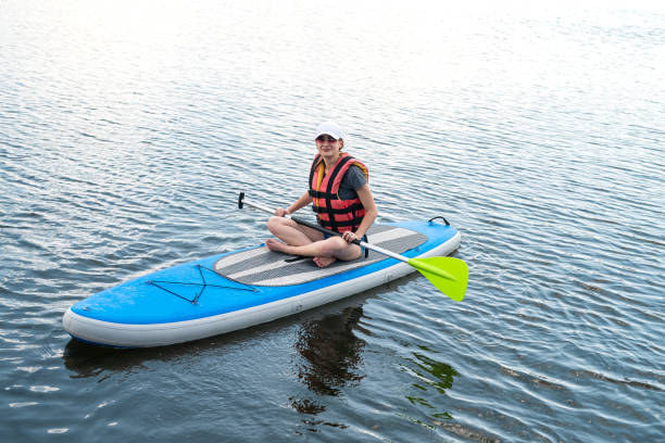 istock Young woman relax on SUP Stand up paddle board in summer time 1398061620