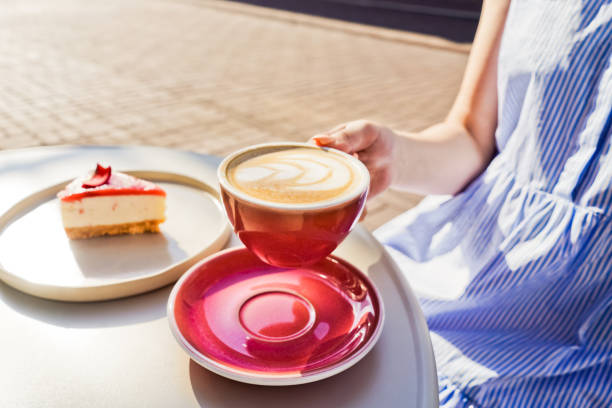 istock Cup of latte coffee in womans hands. 1398063359