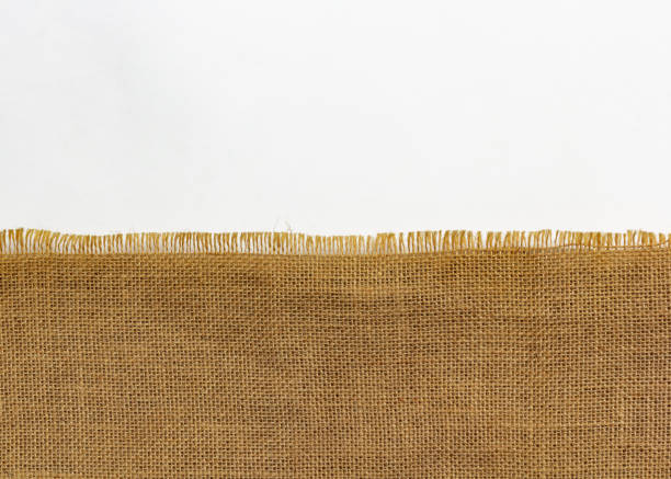 istock Coarse burlap on white, linen cloth bag halved background 1398063996