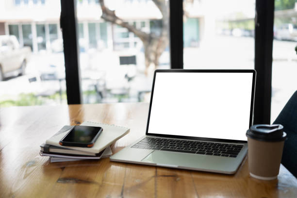 istock Laptop computer, coffee cup and notebook on wooden office desk. 1398064023