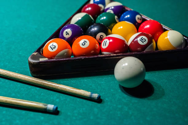 istock Billiard balls on the pool table with player's hands and stick. 1398065677