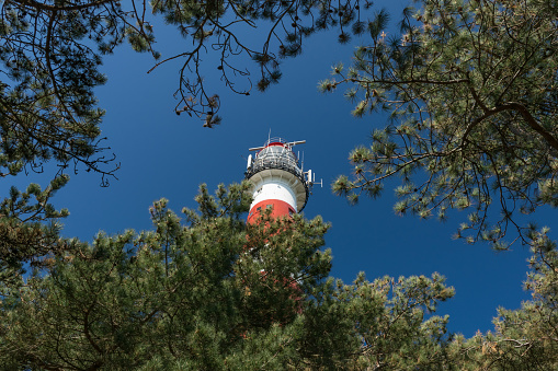 The beautiful classic light house at Ameland island in the Netherlands at a very sunny day.