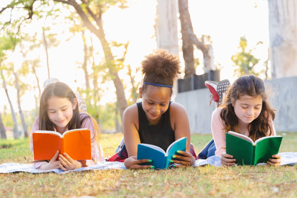 istock Diverse student concepts. Diverse student group lying to read book and enjoy together 1398066314