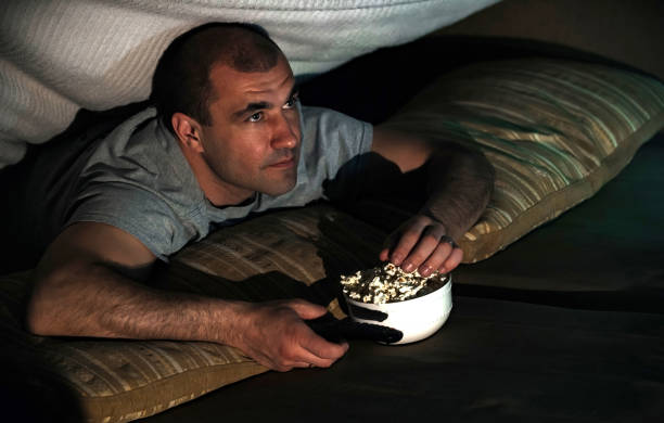 istock man watching tv at home 1398066371