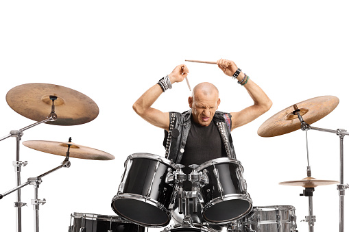 Bald man playing drums isolated on white background