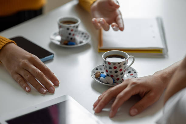Close-up of female hand holding white cup of coffee or tea. Coffee-break, time to rest or short break concept
