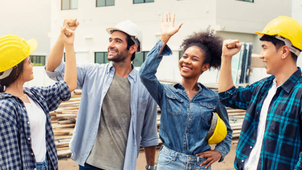istock Engineer and assistants raised their hands and smiling 1398069121