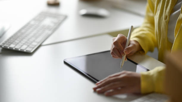 istock Female creative designer working with digital tablet on white table. Cropped shot. 1398069377