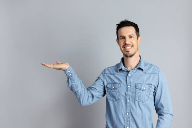 istock Man Gesturing Showing Free Space For Text Aside Standing In Studio 1398069710