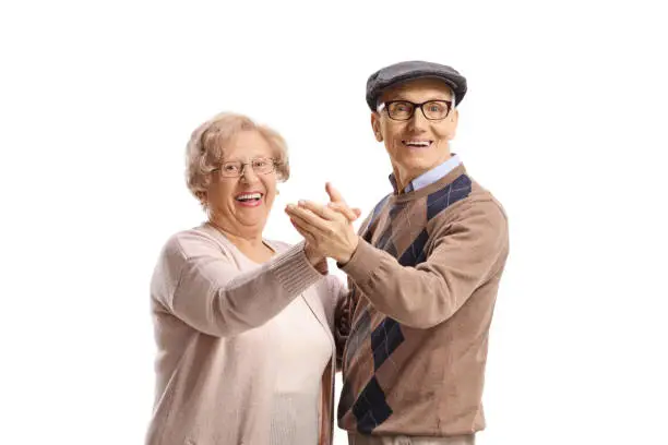 Photo of Happy elderly man and woman dancing tango