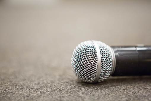 Selective focus of Microphone on stage floor background.