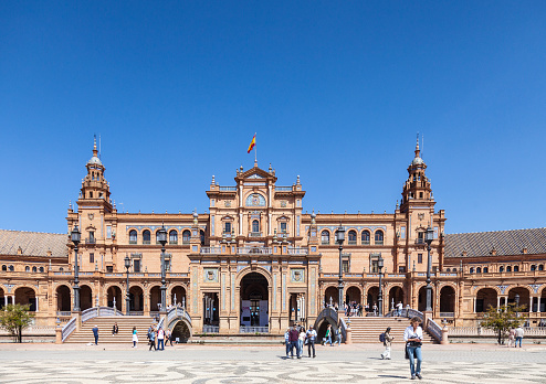 Seville, Spain - 7th April 2022. Visitors and locals enjoying a sunny April day at the Plaza de España. People are walking in the Plaza and admiring the architecture, which was designed by Anibal Gonzalez and completed in 1929  as the Pabellon de Andalucia for Expo 29.