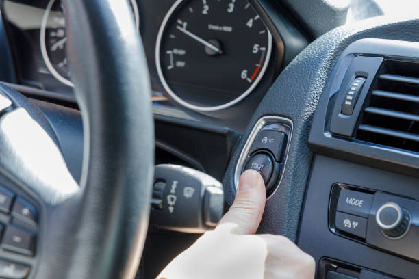 istock Finger pressing the engine start button of a car 1398072156