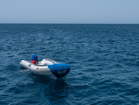 Rubber motor boat Zodiac on the background of the blue sea.