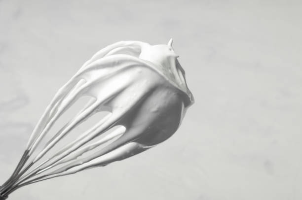 istock corolla with whipped cream or whipped egg whites on a gray background, the whisk is located diagonally, copy space. 1398072678
