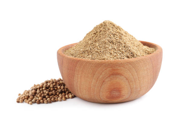 istock Wooden bowl with powdered coriander and corns on white background 1398075204