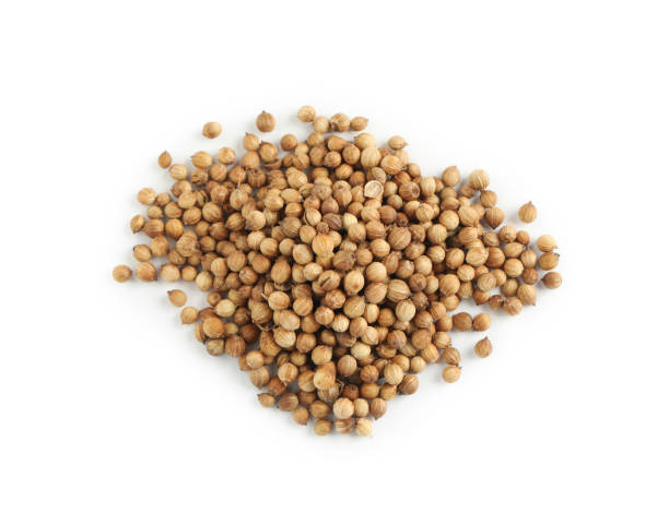 istock Heap of dried coriander seeds on white background, top view 1398075245